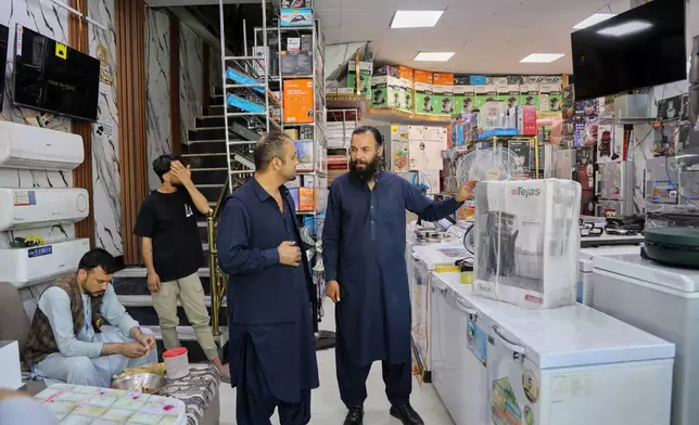 Mohammad Murtaza Ishaqzai, sells electronics in his shop in Kabul, Afghanistan, Wednesday, May 13, 2026. (AP Photo/Siddiqullah Alizai)