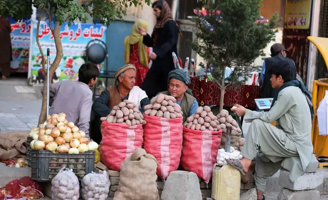 Vendors sell potatoes at their stall in a street market in Kabul, Afghanistan, Thursday, May 14, 2026. (AP Photo/Siddiqullah Alizai)