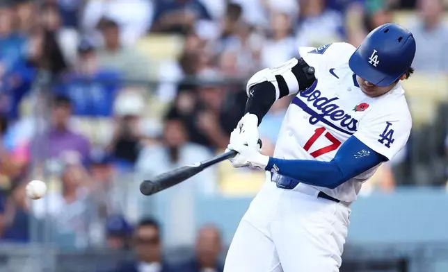 Los Angeles Dodgers' Shohei Ohtani hits a double during the first inning of a baseball game against the Colorado Rockies, Monday, May 25, 2026, in Los Angeles. (AP Photo/Jessie Alcheh)