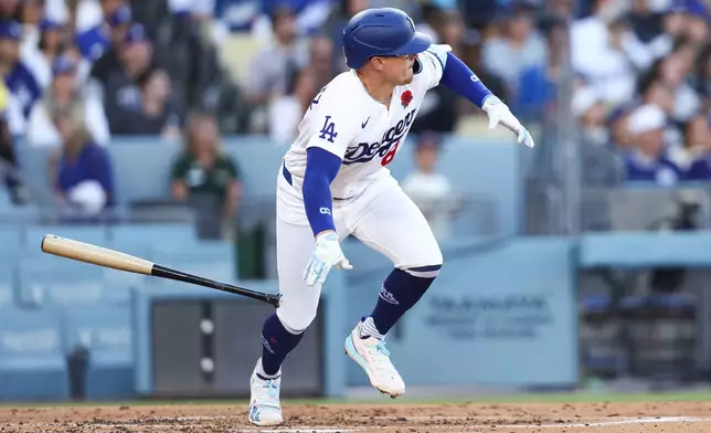 Los Angeles Dodgers' Enrique Hernández drops his bat after hitting an RBI double during the third inning of a baseball game against the Colorado Rockies, Monday, May 25, 2026, in Los Angeles. (AP Photo/Jessie Alcheh)
