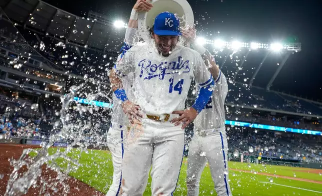 Kansas City Royals' Jac Caglianone (14) is doused by teammates after their baseball game against the Cleveland Guardians, Monday, May 4, 2026, in Kansas City, Mo. (AP Photo/Charlie Riedel)