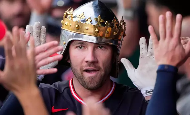 Cleveland Guardians' David Fry celebrates in the dugout after hitting a two-run home run during the second inning of a baseball game against the Kansas City Royals, Monday, May 4, 2026, in Kansas City, Mo. (AP Photo/Charlie Riedel)