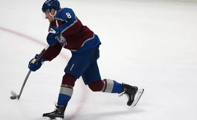 Colorado Avalanche defenseman Cale Makar shoots the puck to score a goal against the Minnesota Wild in the third period of Game 1 of an NHL hockey Stanley Cup second-round playoff series, Sunday, May 3, 2026, in Denver. (AP Photo/David Zalubowski)