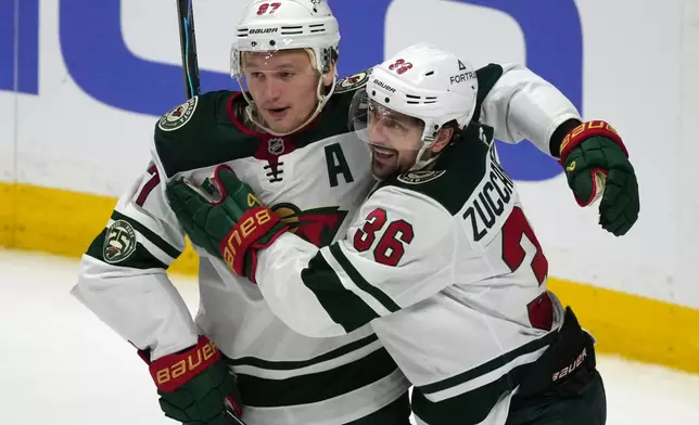 Minnesota Wild left wing Kirill Kaprizov, left, congratulates right wing Mats Zuccarello after he scored a goal against the Colorado Avalanche in the third period of Game 1 of an NHL hockey Stanley Cup second-round playoff series Sunday, May 3, 2026, in Denver. (AP Photo/David Zalubowski)