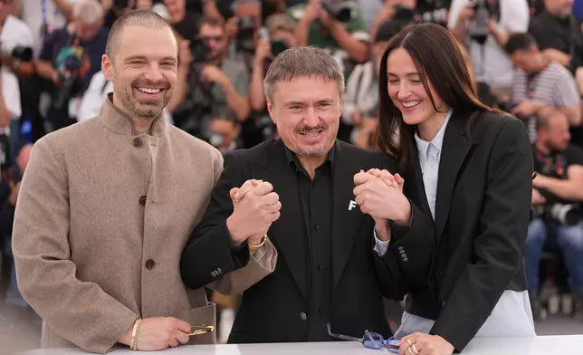 Sebastian Stan, from left, director Cristian Mungiu and Renate Reinsve pose for photographers at the photo call for the film 'Fjord' during the 79th international film festival, Cannes, southern France, Tuesday, May 19, 2026. (AP Photo/Andreea Alexandru)