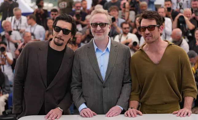 Adam Driver, from left, director James Gray and Miles Teller pose for photographers at the photo call for the film 'Paper Tiger' during the 79th international film festival, Cannes, southern France, Sunday, May 17, 2026. (AP Photo/Andreea Alexandru)