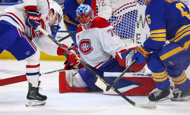 Montreal Canadiens goaltender Jakub Dobes (75) watches the puck during the first period in Game 2 of a second-round NHL hockey Stanley Cup playoff series against the Buffalo Sabres, Friday, May 8, 2026, in Buffalo, N.Y. (AP Photo/Jeffrey T. Barnes)