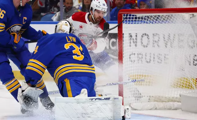 Montreal Canadiens center Alex Newhook (15) puts the puck past Buffalo Sabres goaltender Alex Lyon (34) during the second period in Game 2 of a second-round NHL hockey Stanley Cup playoff series Friday, May 8, 2026, in Buffalo, N.Y. (AP Photo/Jeffrey T. Barnes)