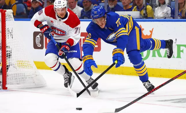 Montréal Canadiens right wing Zachary Bolduc (76) and Buffalo Sabres center Tage Thompson (72) battle for the puck during the first period in Game 2 of a second-round NHL hockey Stanley Cup playoff series Friday, May 8, 2026, in Buffalo, N.Y. (AP Photo/Jeffrey T. Barnes)