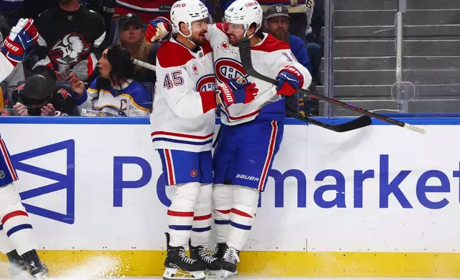 Montreal Canadiens center Alex Newhook (15) celebrates his goal with defenseman Alexandre Carrier (45) during the second period in Game 2 of a second-round NHL hockey Stanley Cup playoff series against the Buffalo Sabres Friday, May 8, 2026, in Buffalo, N.Y. (AP Photo/Jeffrey T. Barnes)