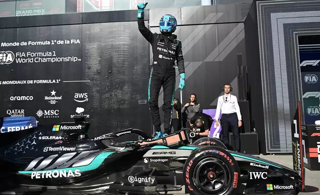 Mercedes driver George Russell of Britain celebrates after taking pole following the sprint qualifying session at the F1 Canadian Grand Prix auto race in Montreal, Friday, May 22, 2026. (Graham Hughes/The Canadian Press via AP)