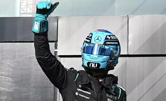 Mercedes driver George Russell of Britain, celebrates after taking pole following the sprint qualifying session at the F1 Canadian Grand Prix auto race in Montreal, Friday, May 22, 2026. (Graham Hughes/The Canadian Press via AP)