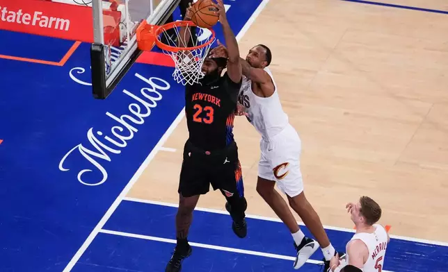 New York Knicks center Mitchell Robinson (23) dunks past Cleveland Cavaliers center Evan Mobley (4) during the second half of Game 2 in the Eastern Conference finals NBA basketball playoffs series, Thursday, May 21, 2026, in New York. (AP Photo/Yuki Iwamura)