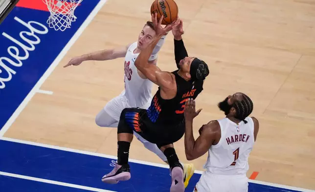 New York Knicks guard Josh Hart (3) is blocked by Cleveland Cavaliers guard Sam Merrill (5) during the second half of Game 2 in the Eastern Conference finals NBA basketball playoffs series, Thursday, May 21, 2026, in New York. (AP Photo/Yuki Iwamura)