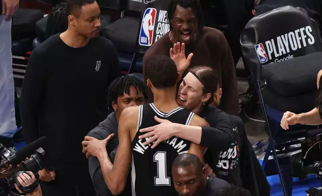 San Antonio Spurs forward Victor Wembanyama (1) celebrates with teammates after winning Game 1 in a third-round NBA basketball playoffs series against the Oklahoma City Thunder Monday, May 18, 2026, in Oklahoma City. (AP Photo/Nate Billings)