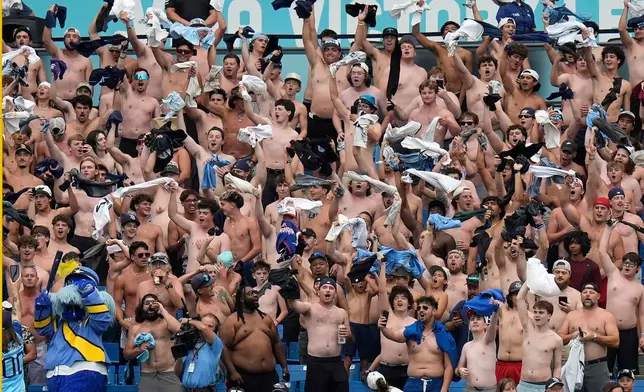 Tampa Bay Rays fans take part in the "tarp off" during the seventh inning of a baseball game against the Baltimore Orioles Wednesday, May 20, 2026, in St. Petersburg, Fla. (AP Photo/Chris O'Meara)