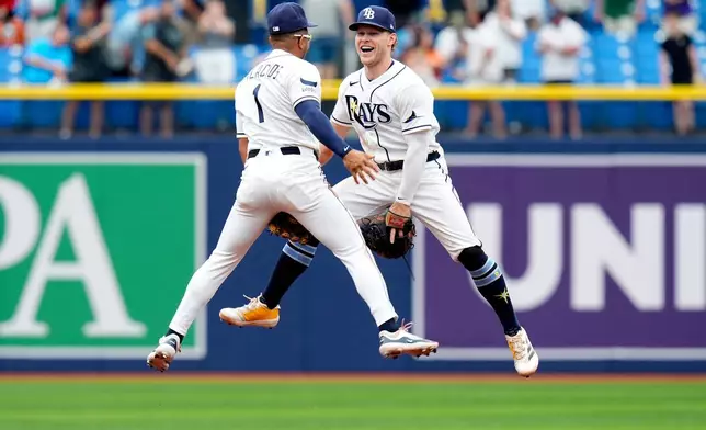 Tampa Bay Rays second baseman Richie Palacios (1) and shortstop Taylor Walls celebrate after the team defeated the Baltimore Orioles during a baseball game Wednesday, May 20, 2026, in St. Petersburg, Fla. (AP Photo/Chris O'Meara)
