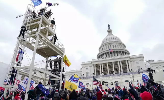 FILE - Trump supporters gather outside the Capitol, Jan. 6, 2021, in Washington. (AP Photo/John Minchillo, File)