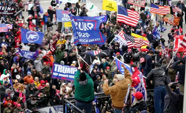 FILE - Violent protesters gather outside the U.S. Capitol, Jan 6, 2021. (AP Photo/Andrew Harnik, File)