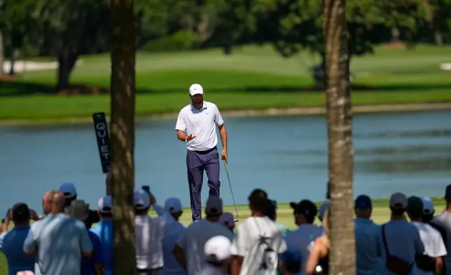 Scottie Scheffler waves after his shot on the seventh green during the second round of the Cadillac Championship PGA golf tournament Friday, May 1, 2026, in Doral, Fla. (AP Photo/David J. Phillip)