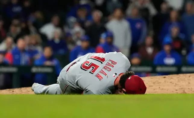 Cincinnati Reds relief pitcher Emilio Pagán lies on the field after an injury during the ninth inning of a baseball game against the Chicago Cubs in Chicago, Tuesday, May 5, 2026. (AP Photo/Nam Y. Huh)