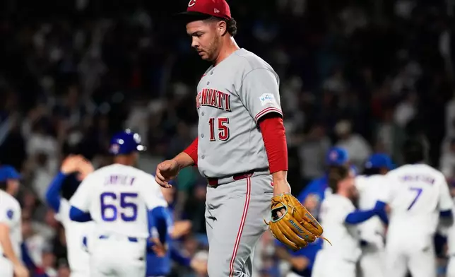 Cincinnati Reds relief pitcher Emilio Pagán (15) walks off the field after Chicago Cubs' Michael Conforto hit the winning solo home run during the ninth inning of a baseball game in Chicago, Monday, May 4, 2026. (AP Photo/Nam Y. Huh)