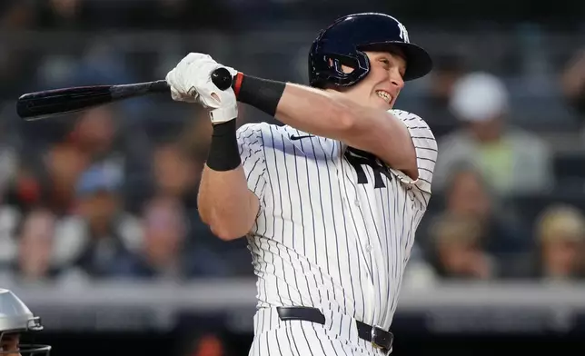 New York Yankees' Ben Rice follows through on a three-run home run during the second inning of a baseball game against the Baltimore Orioles Friday, May 1, 2026, in New York. (AP Photo/Frank Franklin II)