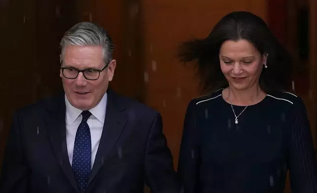 Britain's Prime Minister Keir Starmer and wife Victoria leave 10 Downing Street to attend the State Opening of Parliament at the Houses of Parliament in London, Wednesday, May 13, 2026.(AP Photo/Alberto Pezzali)