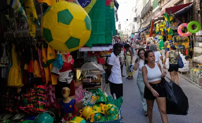Shoppers walk through the Saara street market in Rio de Janeiro, Thursday, April 26, 2026. (AP Photo/Silvia Izquierdo)