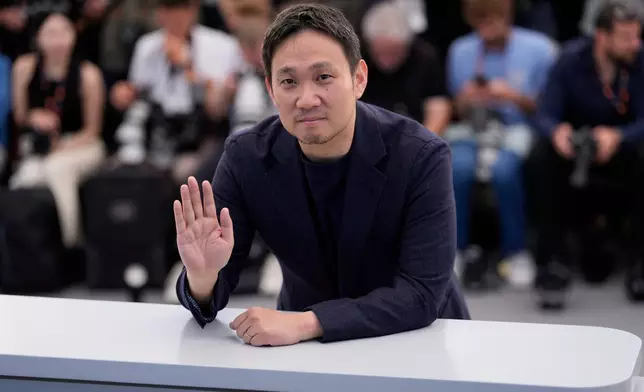 Director Ryûsuke Hamaguchi poses for photographers at the photo call for the film 'All of a Sudden' during the 79th international film festival, Cannes, southern France, Saturday, May 16, 2026. (AP Photo/John Locher)