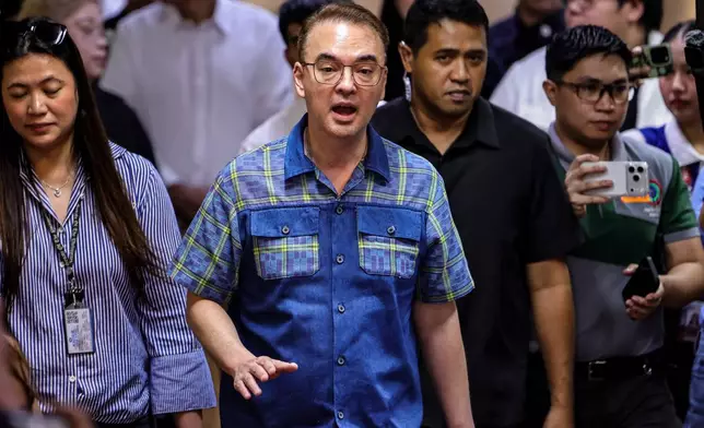 Philippine Senate President Alan Peter Cayetano, center, speaks to the media during a brief press conference at the Senate of the Philippines in Pasay City Thursday, May 14, 2026. (AP Photo/Gerard Carreon)