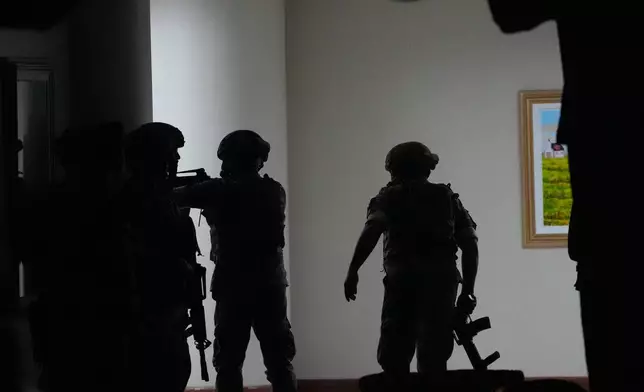 Philippine troopers exchange fire along a hallway at the Philippine Senate in Pasay, Philippines on Wednesday May 13, 2026. (AP Photo/Aaron Favila)