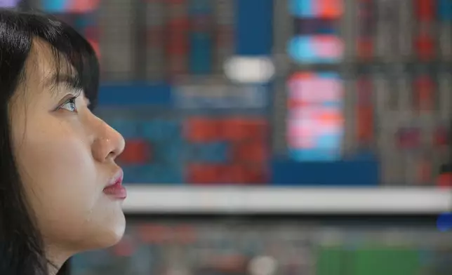 A dealer watches computer monitors at a dealing room of Hana Bank in Seoul, South Korea, Friday, May 15, 2026. (AP Photo/Lee Jin-man)
