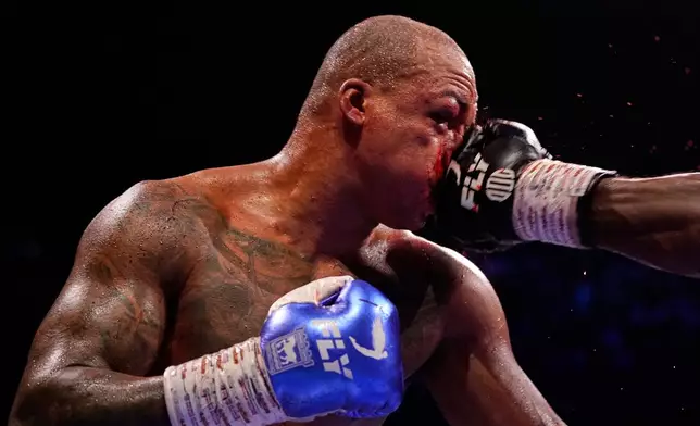 Britain's Fabio Wardley takes a punch to the face from Britain's Daniel Dubois during their WBO World Heavyweight boxing title bout in Manchester, Saturday, May 9, 2026. (AP Photo/Dave Thompson)