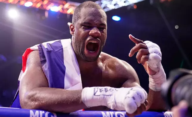 Britain's Daniel Dubois celebrates after beating Britain's Fabio Wardley in a WBO World Heavyweight boxing title bout in Manchester, Saturday, May 9, 2026. (AP Photo/Dave Thompson)