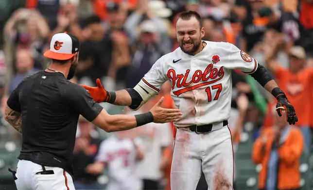 Baltimore Orioles' Colton Cowser, right, celebrates with teammates after hitting a walk off two-run home run during the 13th inning of a baseball game against the Tampa Bay Rays, Monday, May 25, 2026, in Baltimore. (AP Photo/Stephanie Scarbrough)