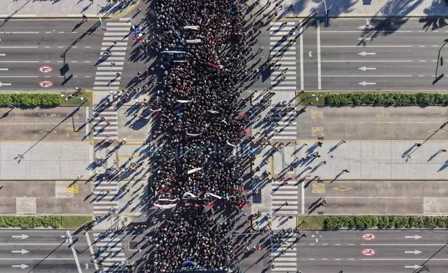Demonstrators march to demand President Javier Milei's government comply with a University of Buenos Aires (UBA) funding law, amid deep budget cuts in Buenos Aires, Argentina, Tuesday, May 12, 2026. (AP Photo/Rodrigo Abd)