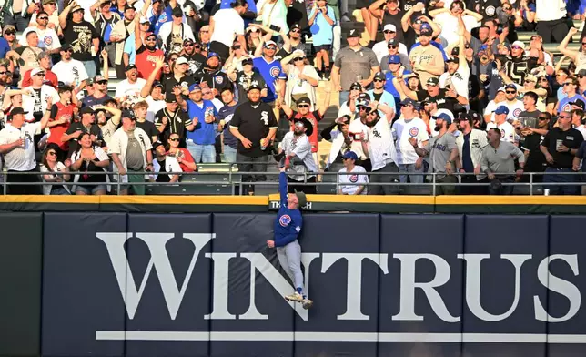 Chicago Cubs center fielder Pete Crow-Armstrong attempts to catch Chicago White Sox's Munetaka Murakami's solo home run during the third inning of a baseball game in Chicago, Saturday, May 16, 2026. (AP Photo/Paul Beaty)