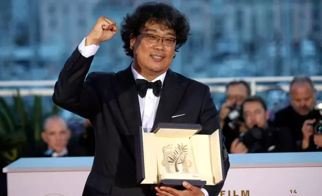 FILE - Director Bong Joon Ho poses with the Palme d'Or award for the film "Parasite" at the 72nd international film festival, Cannes, southern France on May 25, 2019. (AP Photo/Petros Giannakouris, File)