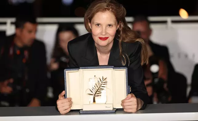 FILE - Justine Triet, winner of the Palme d'Or for "Anatomy of a Fall," poses for photographers during a photo call following the awards ceremony at the 76th international film festival, Cannes, southern France, on May 27, 2023. (Photo by Vianney Le Caer/Invision/AP, File)
