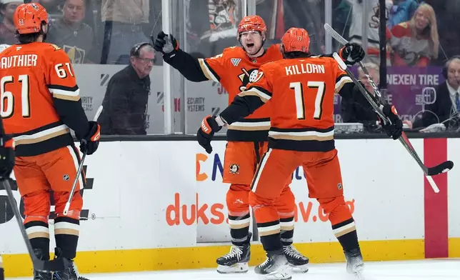 Anaheim Ducks' Beckett Sennecke (45) celebrates his goal against the Vegas Golden Knights with Alex Killorn (17) during the first period of an NHL hockey game, Sunday, May 10, 2026, in Anaheim, Calif. (AP Photo/Scott Strazzante)