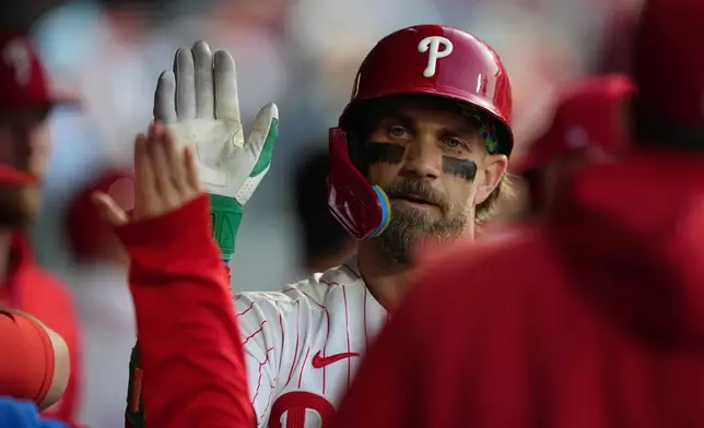 Philadelphia Phillies' Bryce Harper celebrates his home run off of Athletics pitcher Luis Severino during the third inning of a baseball game, Tuesday, May 5, 2026, in Philadelphia. (AP Photo/Matt Rourke)
