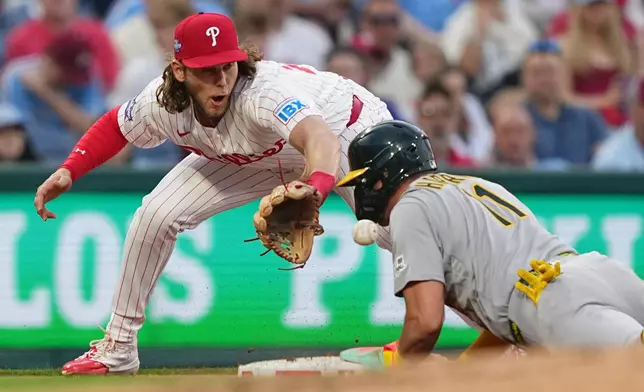 Athletics' Brett Harris beats the throw to Philadelphia Phillies third baseman Alec Bohm during the third inning of a baseball game, Tuesday, May 5, 2026, in Philadelphia. (AP Photo/Matt Rourke)