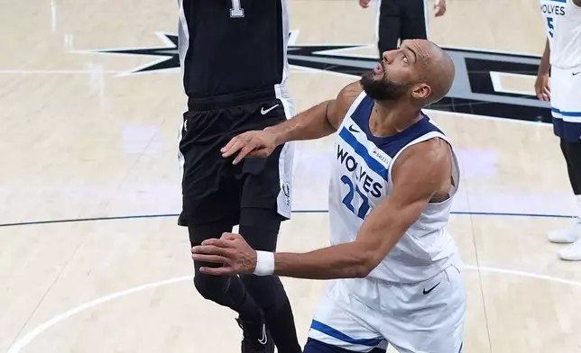 San Antonio Spurs forward Victor Wembanyama (1) drives to the basket against Minnesota Timberwolves center Rudy Gobert (27) during the first half of Game 5 of an NBA basketball second-round playoffs series in Minneapolis, Tuesday, May 12, 2026. (AP Photo/Eric Gay)