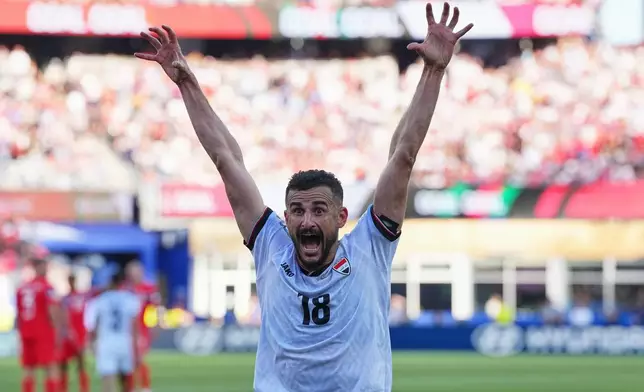 Iraq's Aymen Hussein celebrates scoring his side's first goal during the World Cup Group I soccer match between Iraq and Norway in Foxborough, Mass., near Boston, Tuesday, June 16, 2026. (AP Photo/Martin Meissner)