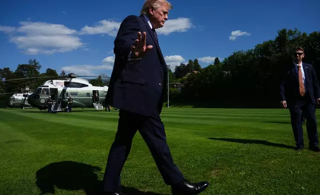 President Donald Trump waves to reporters as he arrives for the G7 summit, Monday, June 15, 2026, in Evian-les-Bains, France. (AP Photo/Julia Demaree Nikhinson)