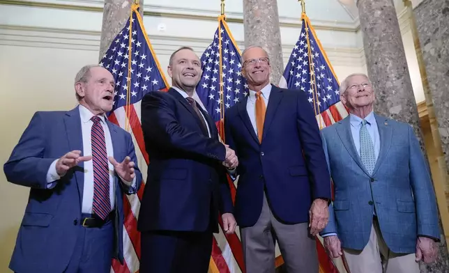 Poland's President Karol Nawrocki, center, shakes hand with Sen. Majority Leader John Thune, R-S.D., as Sen. Jim Risch, R-Idaho, left, Sen. Roger Wicker, R-Miss., right, stand for a group photo before a meeting on Capitol Hill, Monday, June 15, 2026, in Washington. (AP Photo/Mariam Zuhaib)