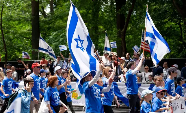 Parade participants wave flags to the crowd during the Israel Day Parade, Sunday, May 31, 2026, in New York. (AP Photo/Emil T. Lippe)