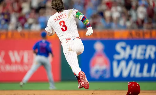 Philadelphia Phillies' Bryce Harper runs the bases on his way to a triple for the cycle during the fifth inning of a baseball game against the New York Mets, Saturday, June 20, 2026, in Philadelphia. (AP Photo/Chris Szagola)