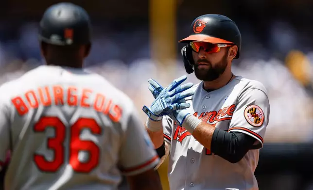 Baltimore Orioles' Colton Cowser, right, reacts after hitting an RBI single during the first inning of a baseball game against the Los Angeles Dodgers, Sunday, June 21, 2026, in Los Angeles. (AP Photo/Caroline Brehman)